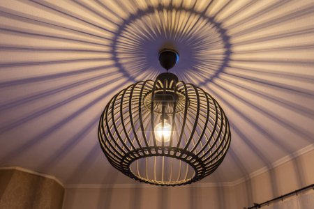 Photo for Modern handmade circular bamboo ceiling lamp. lighting bulbs for office building or home and living room decoration. Light effect - Royalty Free Image