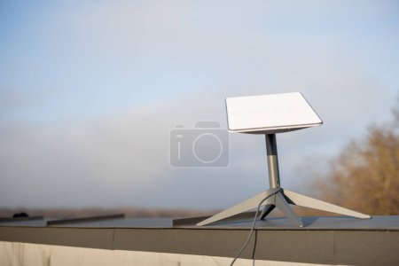 Téléchargez les photos : LVIV, UKRAINE - January, 2023: Starlink satellite dish, internet constellation operated by SpaceX, installed on roof of residential building on sunny day - en image libre de droit