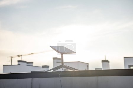 Photo for LVIV, UKRAINE - January, 2023: Starlink satellite dish, internet constellation operated by SpaceX, installed on roof of residential building on sunny day - Royalty Free Image