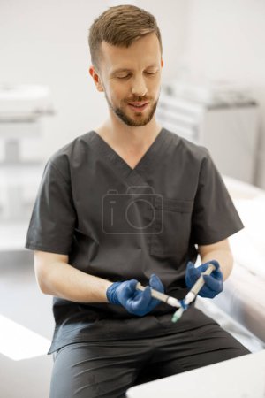 Photo for Phlebologist prepares special solution in syringe for sclerotherapy, portrait of a doctor. Concept of medical treatment of varicose veins - Royalty Free Image