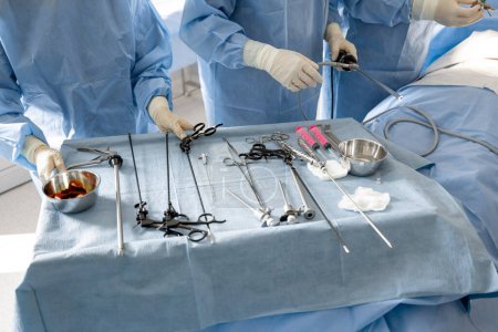 Photo for Surgery treatment in progress, close-up on table with medical tools. Concept of real invasive surgery in operating room - Royalty Free Image