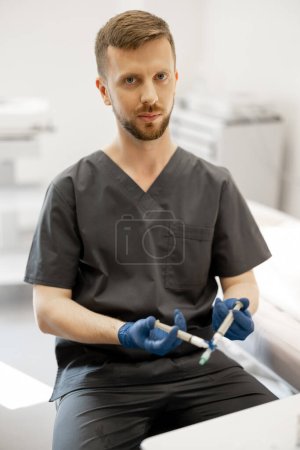 Photo for Phlebologist prepares special solution in syringe for sclerotherapy, portrait of a doctor. Concept of medical treatment of varicose veins - Royalty Free Image
