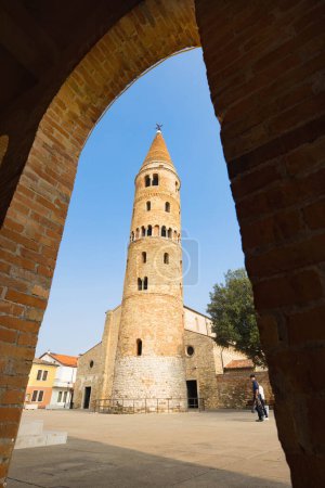 Photo for Caorle Cathedral Tower and cathedral church behind it during sunny day and blue sky - Royalty Free Image