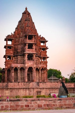 Photo for Ancient hindu temple architecture with girl witnessing it at evening from flat angle at day - Royalty Free Image