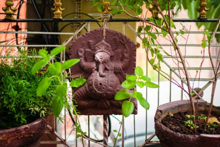 Foto de Hindu god ganesha statue isolated at garden with tulsi tree for pray at day - Imagen libre de derechos