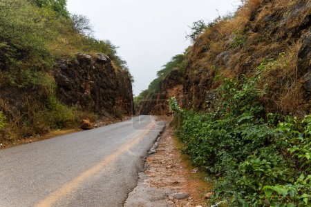 Téléchargez les photos : Isoler la route goudronnée menant aux montagnes le jour de pluie de l'image à angle plat est prise à haldighati rajasthan Inde. - en image libre de droit