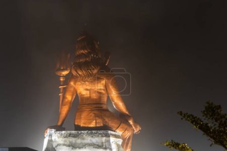 back view of hindu god lord shiva isolated statue at night from different angle image is taken at statue of belief nathdwara rajasthan india.