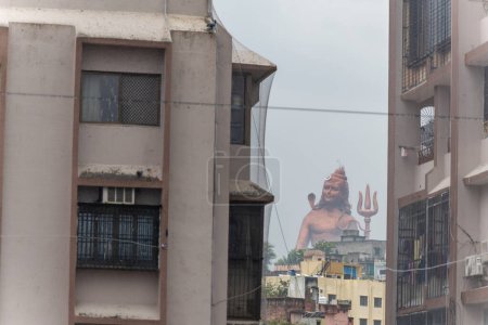 hindu god lord shiva isolated statue through building gaps at morning from different angle image is taken at statue of belief nathdwara rajasthan india.