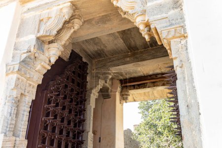 ancient fort entrance wood door with iron thorns at morning image is taken at Kumbhal fort kumbhalgarh rajasthan india.