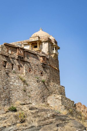 isolated ancient fort stone wall with unique architecture with bright blue sky at morning image is taken at Kumbhal fort kumbhalgarh rajasthan india.