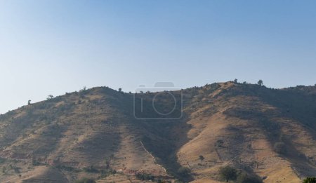 isolated mountain with bright blue sky at morning from flat angle
