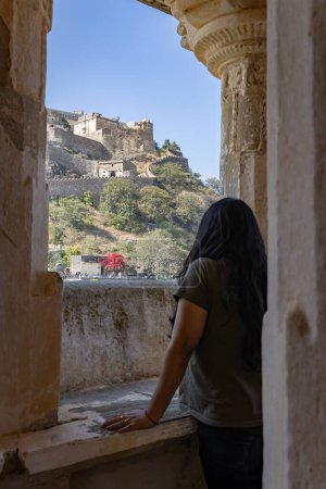 young girl looking at historic fort at morning from flat angle