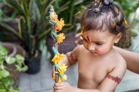 Portrait of cute Indian boy dresses as lord rama with bow at outdoor with blurred background at day