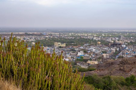 city view with misty sky at evening from mountain top image is taken at mehrangarh fort jodhpur rajasthan india.