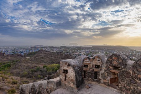 city view with ancient fort wall and dramatic sky at evening from different angle image is taken at mehrangarh fort jodhpur rajasthan india.