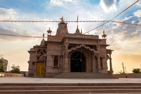 artistic hindu temple with dramatic sunset sky at evening from unique perspective image is taken at Shri Yade Mata Pawan Dham temple jodhpur rajasthan india.