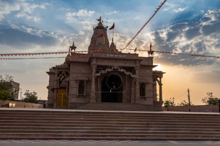 artistic hindu temple with dramatic sunset sky at evening from unique perspective image is taken at Shri Yade Mata Pawan Dham temple jodhpur rajasthan india.
