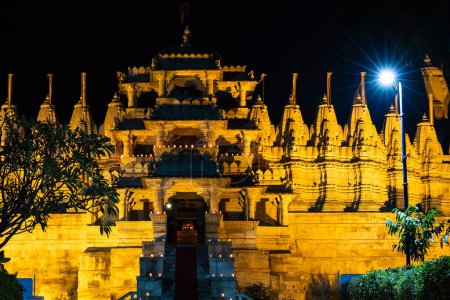 illuminated ancient unique temple architecture at night from different angle image is taken at ranakpur jain temple rajasthan india.