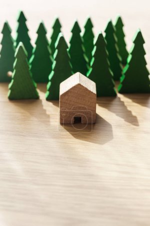Close up shot of a wooden house isolated in the middle of a forest. Sustainable, renewable, real estate and insurance housing concept. Copy space. Vertical.