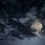 Cloudy full moon night sky with stars