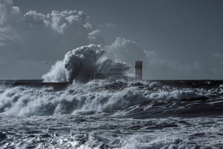 Photo for Huge stormy wave splash over pier and beacon - used infrared filter - Royalty Free Image