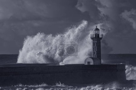 Photo for Big stormy wave splash in the old lighthouse. Used infrared filter. Toned blue. - Royalty Free Image