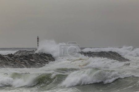 Photo for Breakwater and beacon under storm from Angeiras small harbor, north of Portugal. - Royalty Free Image