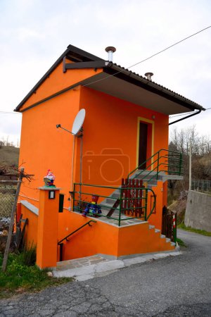 charakteristisches farbiges Landhaus mit Satellitenschüssel Millesimo Italien