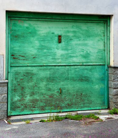 Photo for Characteristic green wooden door in millesimo savona italy - Royalty Free Image