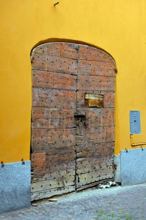 Photo for Characteristic historic wooden door in millesimo savona ital - Royalty Free Image