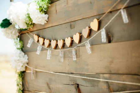 Photo for Wooden board with heart shaped garland and string lights - wedding welcome sign - Royalty Free Image