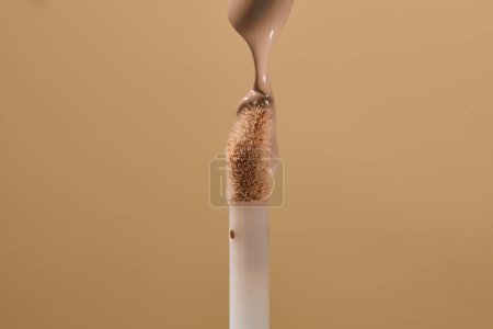 Faoundation concealer wand with product drip. Make up liquid drop on applicator