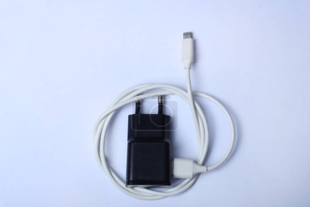 Photo for Charger with a white cable on a light background - Royalty Free Image