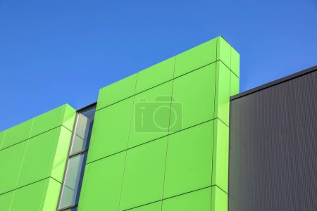 abstract image of green metal wall against the blue sky
