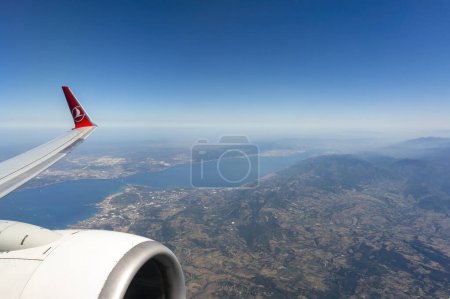 Photo for ISTANBUL, TURKEY, SEPTEMBER 13, 2017: THY airliner flying over Gebze And Yalova Regions, Marmara Sea and Osmangazi Bridge can be seen below. - Royalty Free Image