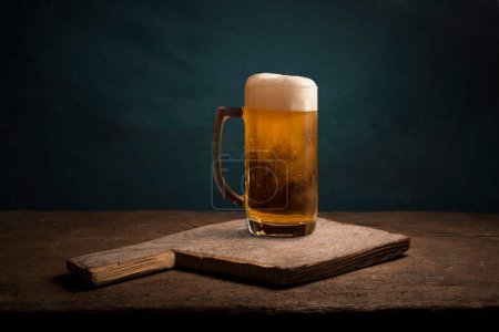 Photo for Mug of beer, wheat ears, hops and beer barrel on a wooden background. High quality photo - Royalty Free Image