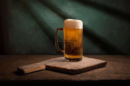 Photo for Mug of beer, wheat ears, hops and beer barrel on a wooden background. High quality photo - Royalty Free Image