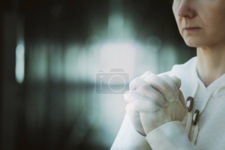 Photo for Double exposure of a woman praying against a blurred background. - Royalty Free Image