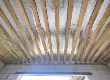 Photo for Construction stage lined ceiling wood and steam insulation layer. - Royalty Free Image