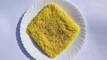 Photo for Traditional special Gujarati sweet Sutarfeni made with shredded vermicelli all purpose flour with melted sugar and clarified butter. Tasty delicate Sutar feni made in GUjarat - Royalty Free Image