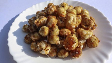 Delicious homemade snack item Caramalized Fox nuts or Makhana snack. Home made puffed lotus seed caramel crispy dish