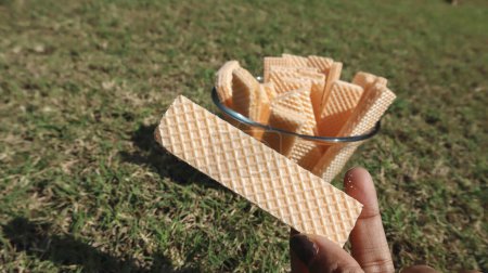 Tasty Wafer biscuits served in a transparent bowl. Orange flavoured wafers sweet and crispy