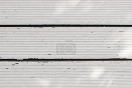 Photo for Vintage white wooden table background in sunlight. Washed old wood texture, summer abstract neutral background. Aged grunge wooden horizontal panels, timber boards. Flat lay, top view, no people. - Royalty Free Image