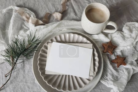 Photo for Christmas still life. Blank horizontal greeting card, invitation mockup. Scalloped plate. Wooden stars, pine tree branches. White linen tablecloth. Cup of coffee, winter breakfast, flatlay, top view - Royalty Free Image