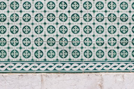 Photo for Closeup of decorative floral tiles. Traditional Portuguese ceramic tile pattern, azulejos. Cclover. Irish green color. Beautiful facade, wall decoration of old Lisbon building. Portugal, background. - Royalty Free Image