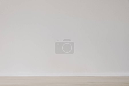 Photo for Modern interior mockup. Simple background with empty beige wooden floor and blank white wall. Scandinavian home. Space, room for product display, house. Apartment. Indoor architecture concept. - Royalty Free Image