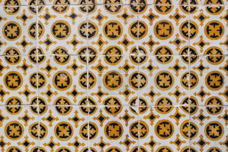 Photo for Traditional Portuguese ceramic azulejos tiles, retro pattern. Beautiful shabby yellow, brown facade, wall banner. Old Lisbon building. Portugal decorative background with geometric floral ornaments. - Royalty Free Image