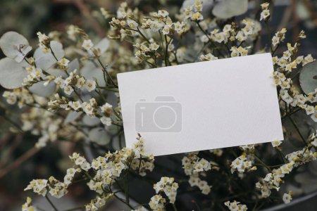 Photo for Floral wedding, birthday mockup. Blank textured paper business card, invitation. Limonium flowers and eucalyptus tree branches bouquet in metal bucket. Blurred background, floristry concept. Top - Royalty Free Image