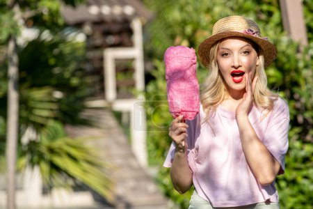 Photo for Cute girl lovely pretty young blonde girl in hat in the summer at the park calling - Royalty Free Image