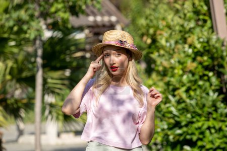 Téléchargez les photos : Fille mignonne jolie jeune fille blonde en chapeau en été au parc en pensant à lui - en image libre de droit